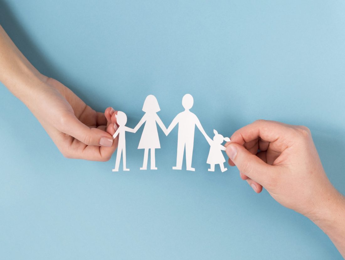 top-view-people-holding-hands-cute-paper-family